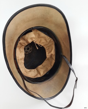 View shows fabric lining of brim, leather sweatband, adjustable sweatband lining and leather chinstrap