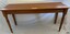 Timber table in location showing brass plaque on top