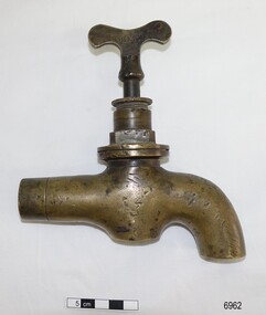 Heavy duty brass tap with dents and scratches, maker's stamp on handle