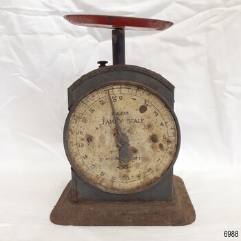 Scale has maker's details. A round dish is on the top of the scale.