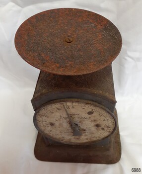 Scale's dis was originally red but paint is worn and flaked
