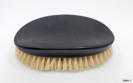 Hairbrush with ebonised hand grip and yellow bristles