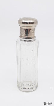 Clear glass bottle with silver metal lid