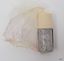 Silver foil around shave stick has embossed text
