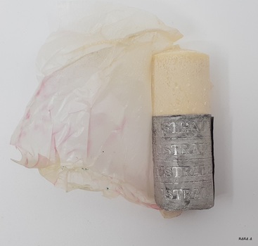Silver foil around shave stick has embossed text
