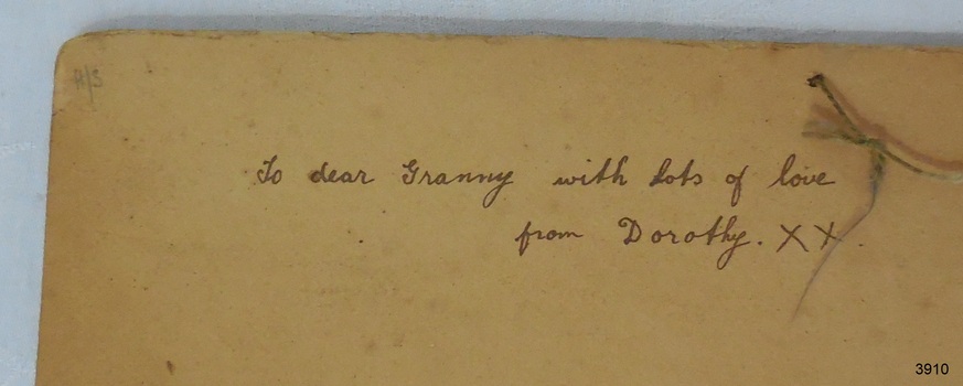 Inscription on back of card. String tied into holes in top of card.