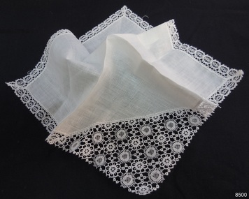 White cotton handkerchief with one corner cut off and lace piece inserted, matching lace border