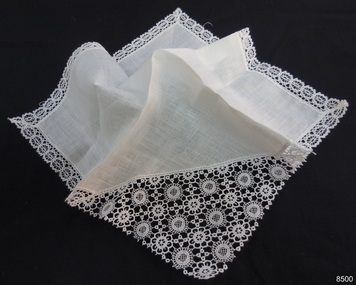 White cotton handkerchief with one corner cut off and lace piece inserted, matching lace border