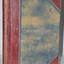 Cover is green fabric with red reinforcing on corners and spine. The reinforcing is trimmed with a gold line on the edges. The title is in gold print.