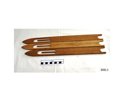 Three wooden shuttles, shaped and smoothed for weaving net