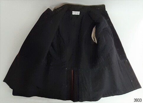 Tunic is lined with black fabric apart from sleeves, which have white fabric with black stripes