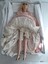 Front view of the Boudoir Doll's porcelain legs, gold painted shoes and white embroidered bloomers.