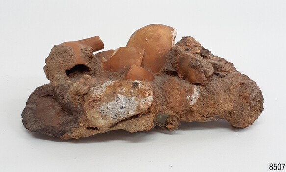 Pipe bowls and portions of stems are visible in the conglomeration