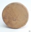 Base has rounded edges, uneven texture and a large chip