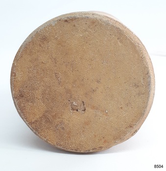 Base has rounded edges, uneven texture and a large chip