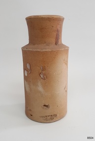 Earthenware jar in brown clay has wide mouth and thick neck, short shoulders and slightly inward tapering body.