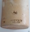 Inscription is impressed into the clay in two lines. There is a large chip above the inscription