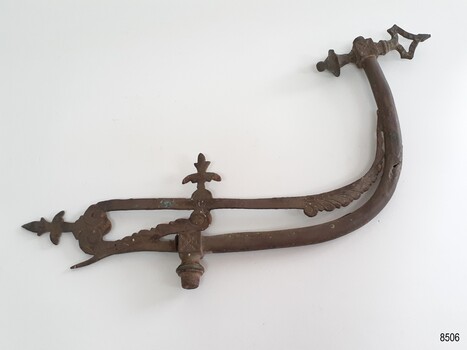 Metal, J shaped gas lamp fitting with fancy fleur-de-lies-like and feather design decoration