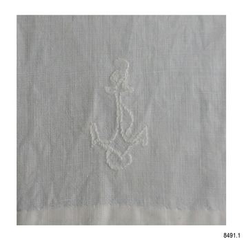 Embroidered symbol of rope entwined around an anchor, white cotton on white cloth