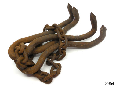 Grappling hook comprises two U shaped lengths of iron with pointed flukes on the ends, joined by chain.
