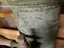 Close-up view of the maker's plate, partly obscured by the plumbing fitting