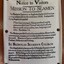 Black ink printed text on white fabric, pinned to the wall as a poster