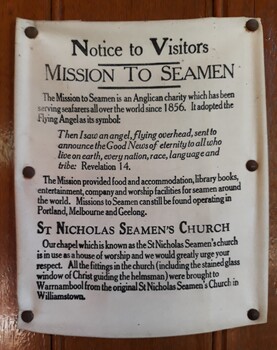 Black ink printed text on white fabric, pinned to the wall as a poster