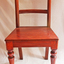 Front of stained wooden chair with curved backrest