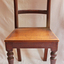 The chair has a curved backrest and one rail below it