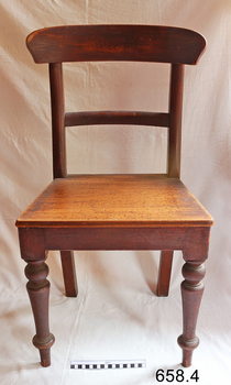 The chair has a curved backrest and one rail below it