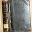 Black cloth hardcover book with embossed gold text on spine