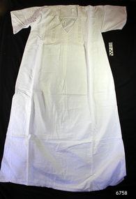 White fabric garment with inlaid lace