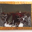 The gilt frame's edges is roughly folded over the edge of the glass