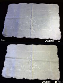 White cotton pair of pillow shams with gently scalloped edges and embroidery including a bird morif