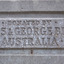 The inscription has been moulded into a bevelled, rectangular plaque on the concrete pediment. The text is all in capital letters spread across three rows. The top row is in smaller letters. The words are “Donated by Annis and George Bills Australia”.