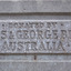 The inscription has been moulded into a bevelled, rectangular plaque on the concrete pediment. The text is all in capital letters spread across three rows. The top row is in smaller letters. The words are “Donated by Annis and George Bills Australia”.