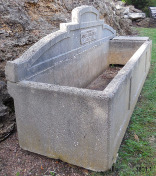 The wall of the compartment on the right end is slightly raised above the base of the trough, which would allow the contents of the trough to flow underneath it. The changes in colour again show that there has been different levels of contents in the trough. 
