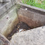 The back wall has a metal fitting within the concrete. The back and right walls show different colours at different levels. The ledge for the cap is visible on the left, rear and right walls.
