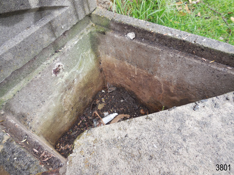 The back wall has a metal fitting within the concrete. The back and right walls show different colours at different levels. The ledge for the cap is visible on the left, rear and right walls.