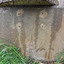 There are five round, lighter coloured areas around metal within the concrete of the trough.