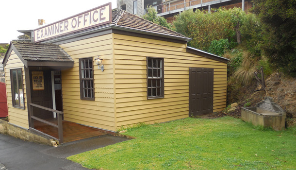 The trough is situated against the rock embankment on the right hand side of the Examiner Office and close to the back wall. It is visible from the footpath along the Village’s cobbled street.