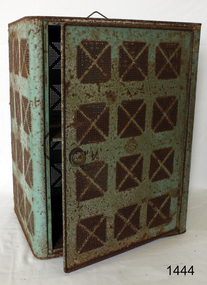 Rectangular cupboard, green painted metal, door on one side, handle at top, sides have airflow holes