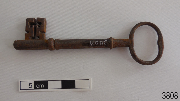 Other side of iron latch key with oval handle