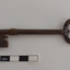 Iron latch key on bench. Oval handle.