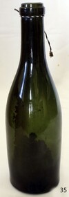 Green glass bottle with concave base