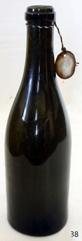 Green glass bottle with push-up base and applied outh