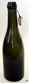 Green glass bottle with tag