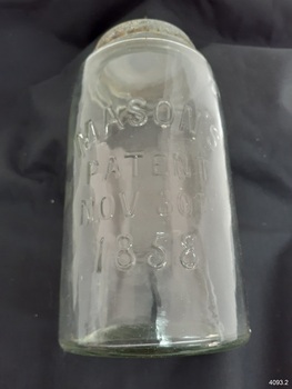 Glass jar with embossed inscriptions on one side