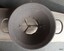 Metal chamber has inscription, clips for holding discs in place and three braces below the food exit