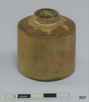 Straight sided round clay bottle with short neck and narrow mouth